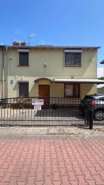 a house with a for sale sign in front of it at Przystań przy Krzywej in Dziwnów