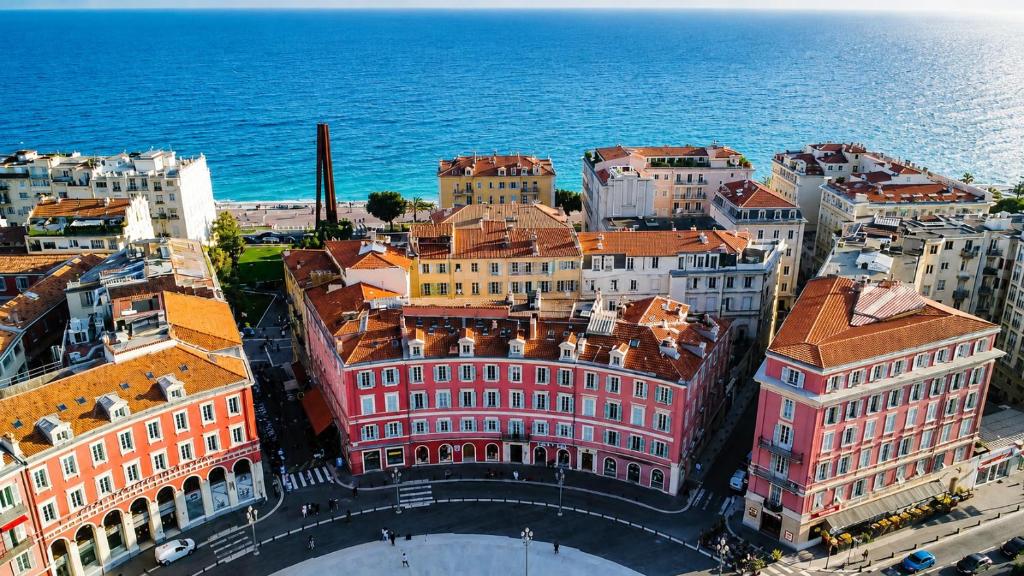 an aerial view of a city next to the ocean at Hotel De La Mer in Nice