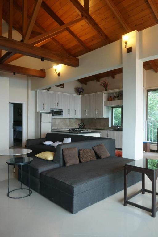 a living room with a couch and a table at Wisteria Cottage in Dunga Gali