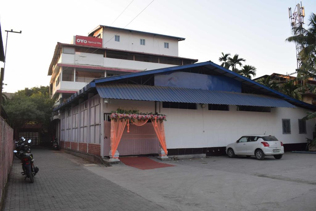 a white car parked in front of a building at Hotel O SPRINGVILLA in Dispur