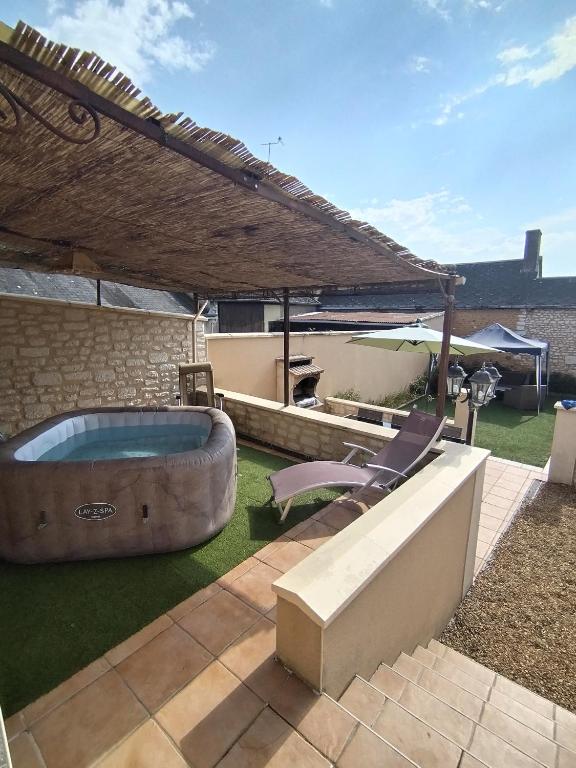 a backyard with a hot tub in the grass at La maison du petit peintre in Villaines-sous-Lucé