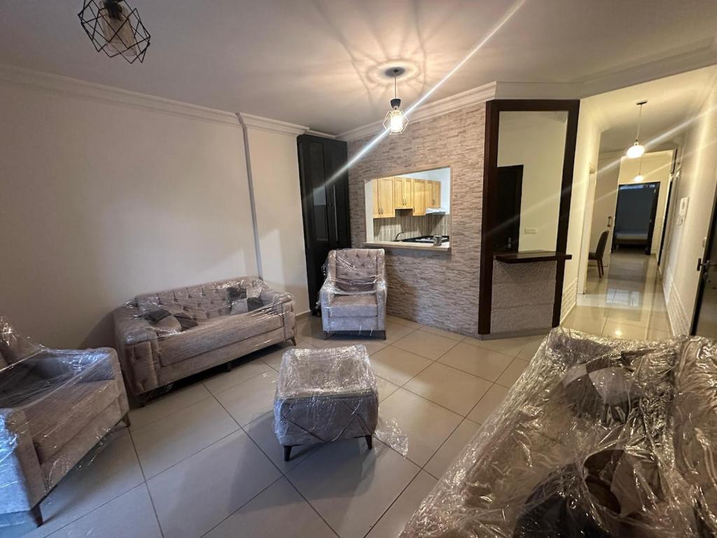 a living room with a couch and chairs and a mirror at Berbara, Chadi in Dayr Jannīn