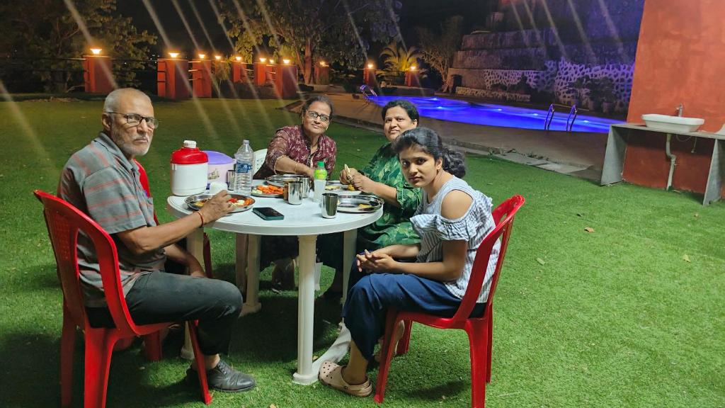 a group of people sitting at a table in front of a stage at LODHA VINTAGE Atdc in Kolvan
