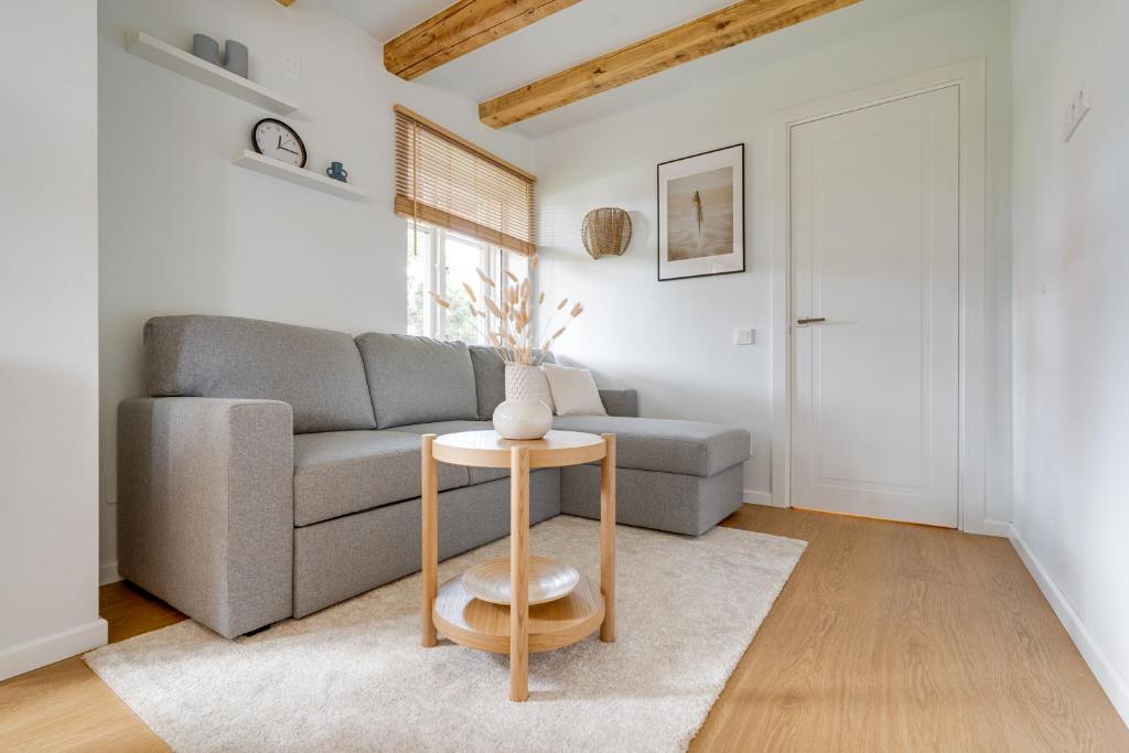 ein Wohnzimmer mit Sofa und Tisch in der Unterkunft Corner House in Nida