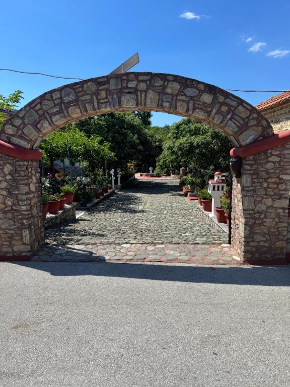 an archway over a stone walkway with a road at PERDIKI STUDIOS in Kokkino Nero
