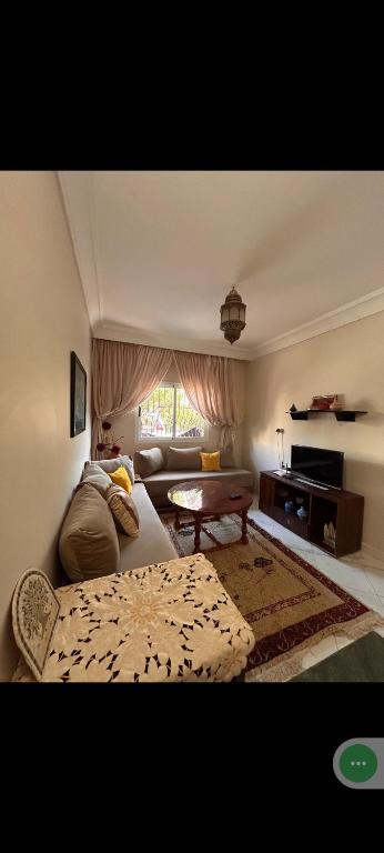 a living room with a couch and a table at Appart Dakhla Cool in Dakhla
