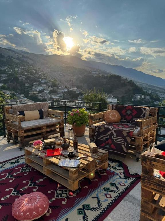 a balcony with furniture and a view of a city at Golden Guest House in Gjirokastër