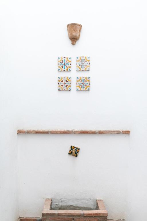 a room with a white wall with three pictures on the wall at Patio Morisco - WIFI - free parking in Órgiva