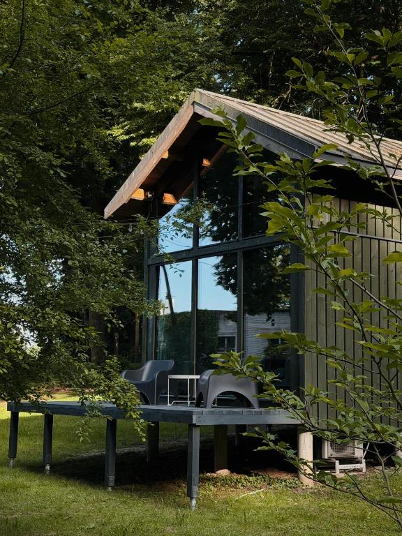 a small house with a table and chairs in it at River Nest Tiny House in Iecava