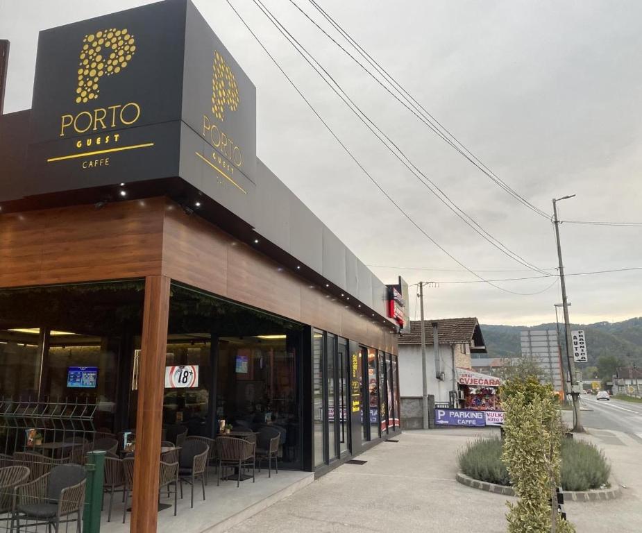 a restaurant with tables and chairs on a street at Porto Apartmani in Zvornik