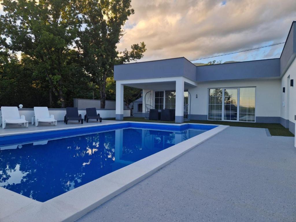 a swimming pool in the backyard of a house at Villa Martar in Mostar