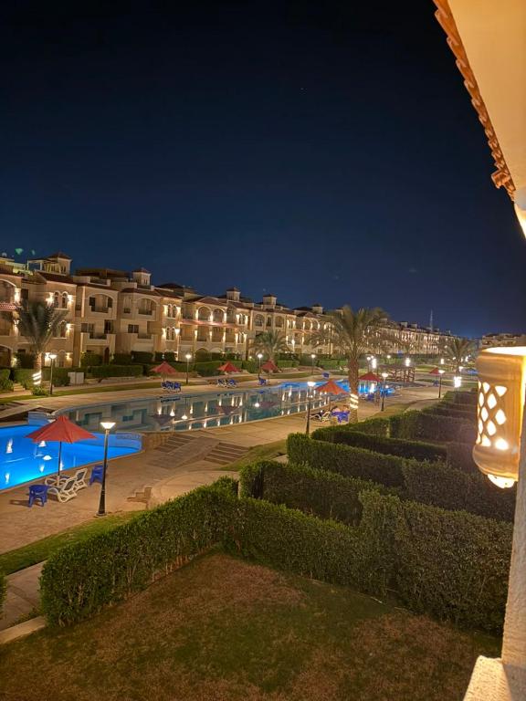 a view of a swimming pool at night at Fahd palm beach chalet in Ain Sokhna