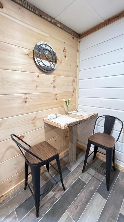 a bench and a table and two chairs on a patio at cozy corner in Dalton