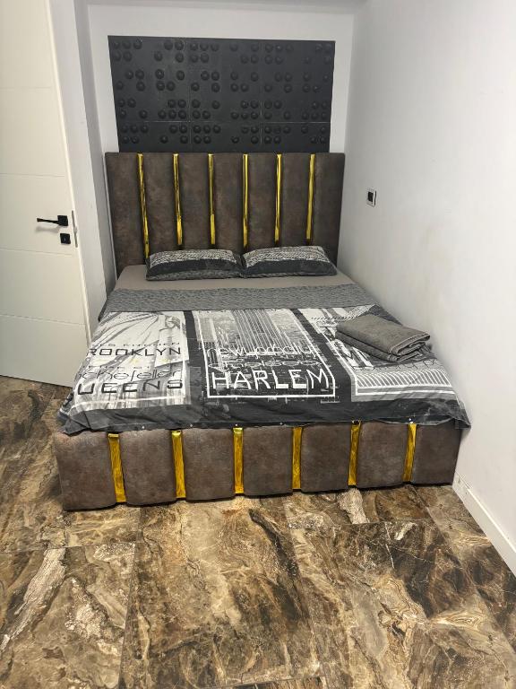 a bedroom with a bed with a black headboard at Apartament bloc nou - self check in - free parking in Craiova