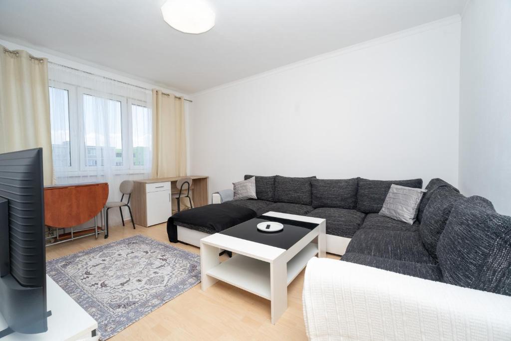 a living room with a couch and a tv at Nesporova Apartment in Košice