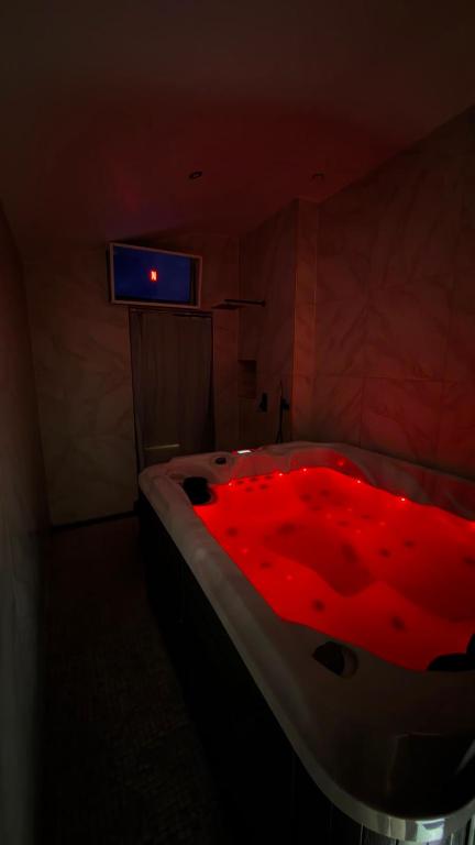 a bathroom with a tub with a red blanket on it at Sauna spa in Rouen