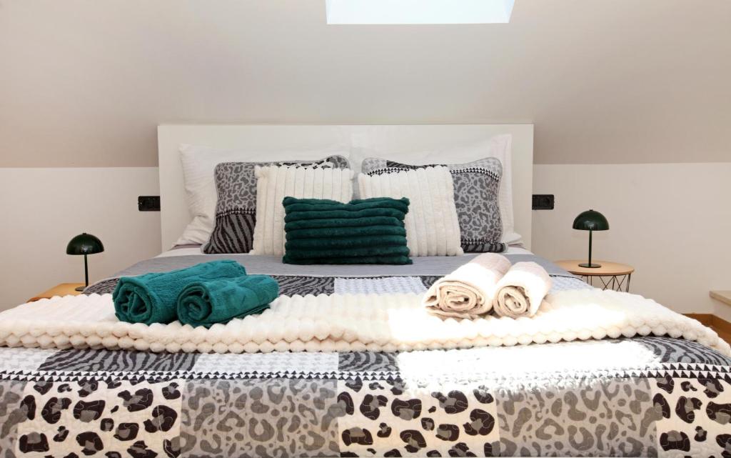 a bedroom with a large bed with towels on it at Old town Bol apartments in Bol