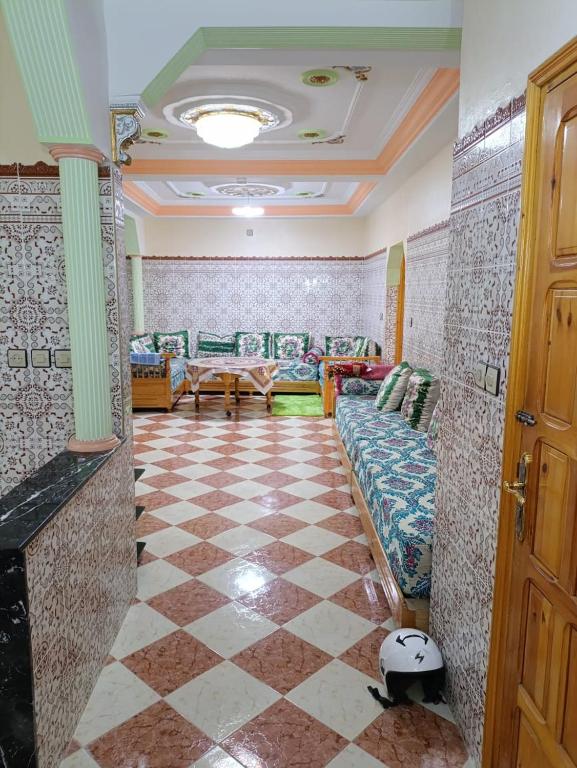 a living room with a couch and a checkered floor at Set in Taza