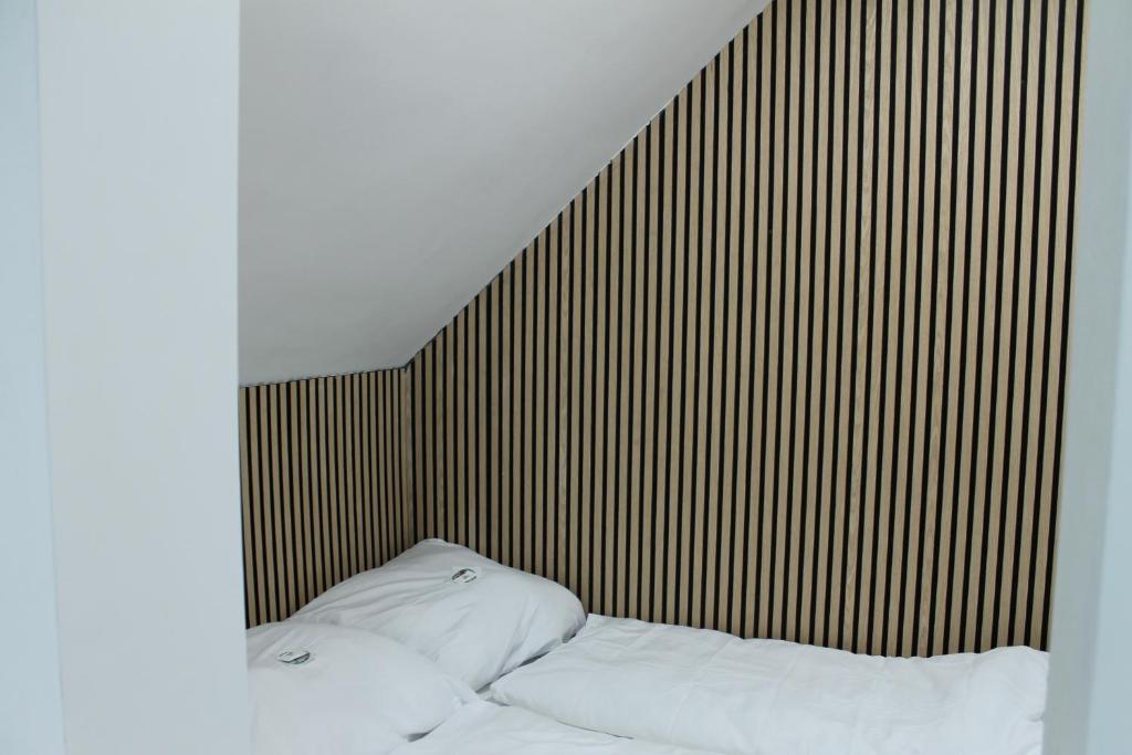 a bed with two white pillows in a room at Royal Racing Suite Top 6 near Red Bull Ring in Judenburg