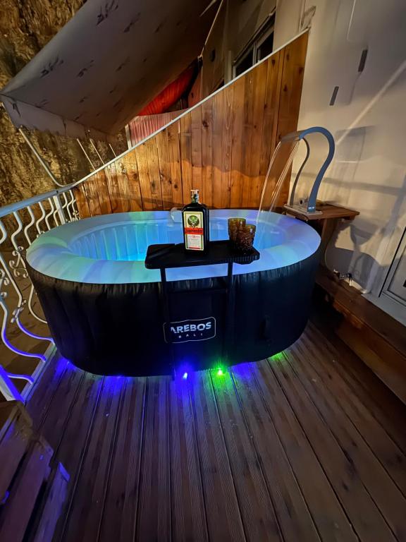 a bath tub in a room with a wooden floor at Romance Apartments in Sarandë