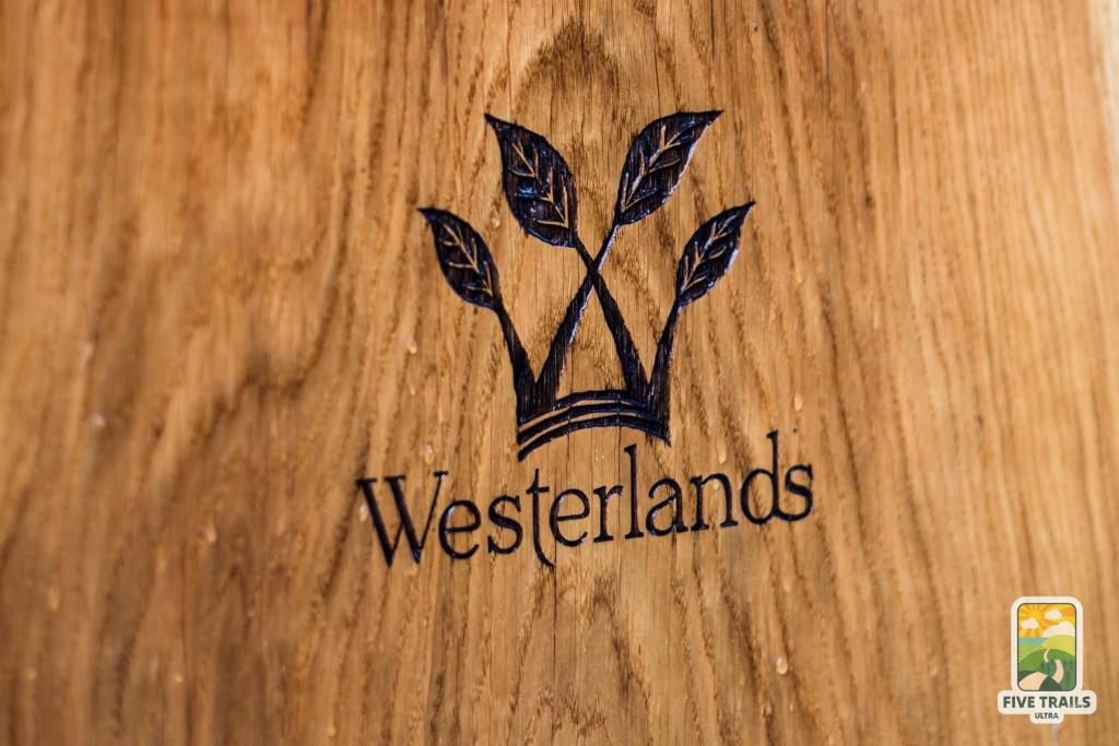 a logo on a wooden table with the wordwesternamines at Westerlands Farm in Graffham