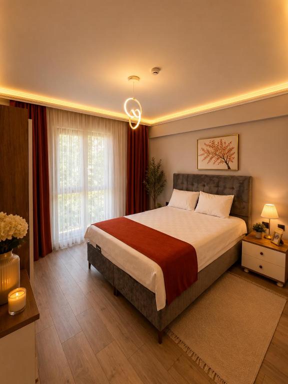 a bedroom with a large bed and a window at Mahal house in Pelitli