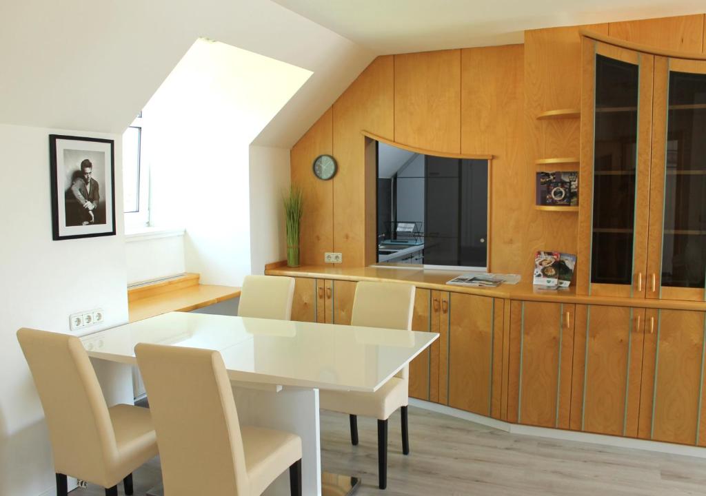 a dining room with a white table and chairs at Royal Racing Suite Top 1 near Red Bull Ring in Judenburg