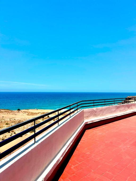 a walkway to the beach with the ocean in the background at Gated oceanfront residence - chic apartment in Salé
