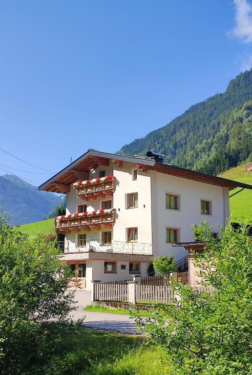 a building with balconies on the side of it at Haus Enzian in Mittersill
