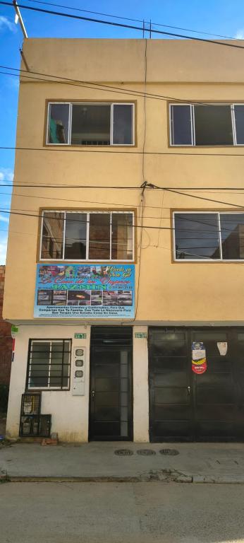 a building with two garages in front of it at La casa de los viajeros Jazmin in San Gil