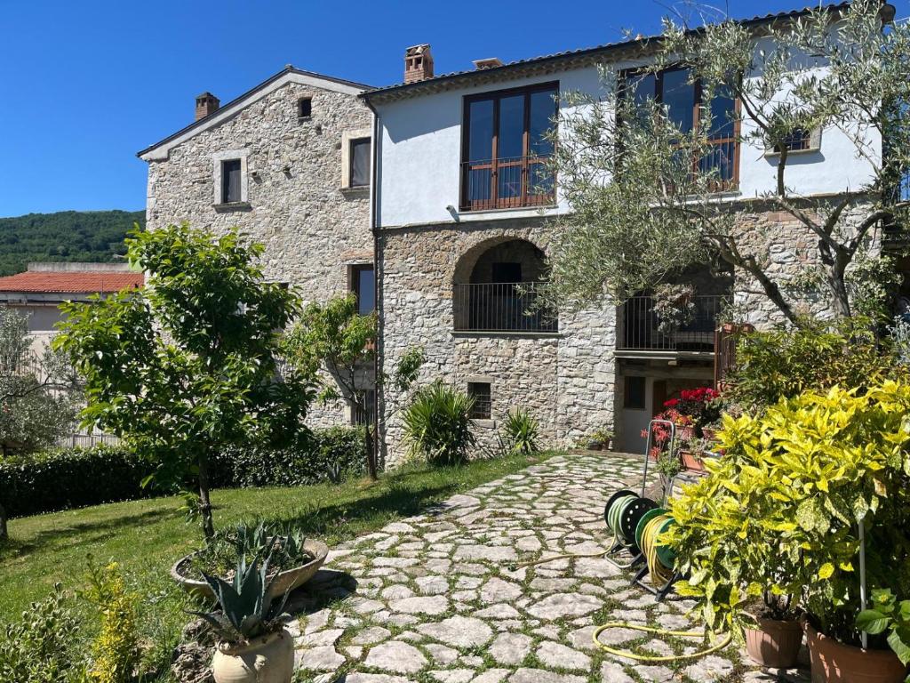 a stone house with a stone path in front of it at Il Convento di Frida in Civitanova del Sannio