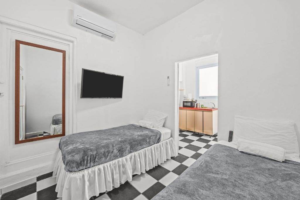 a bedroom with a bed and a tv on the wall at LISBD7D - JL Condado in San Juan