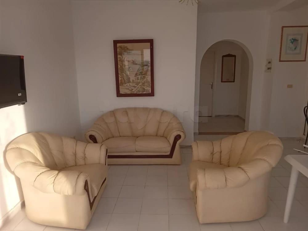 two chairs and a couch in a living room at Marina tabarka in Tabarka