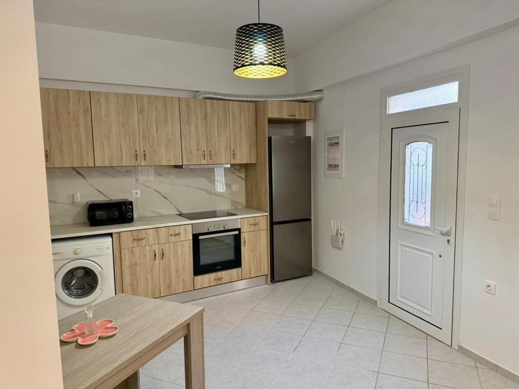 a kitchen with a table and a stove top oven at Dimitra's House in Kefalos