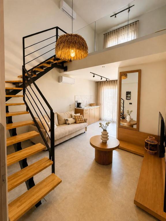 a living room with a spiral staircase and a couch at Estia Luxury Suites & Spa in Platamonas
