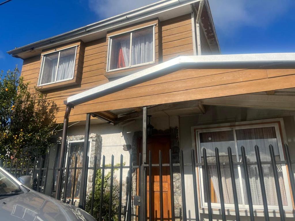 a house with a fence in front of it at Alojamiento Halcones in Concepción