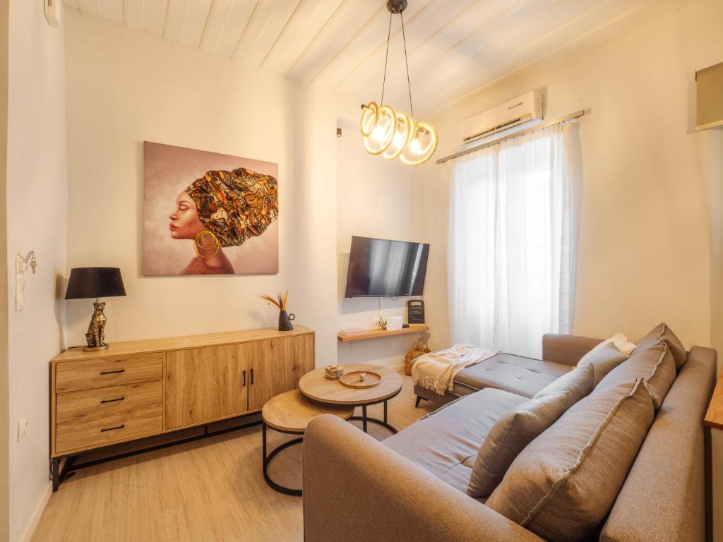 a living room with a couch and a tv at Nena's Volto, Campiello living in Corfu