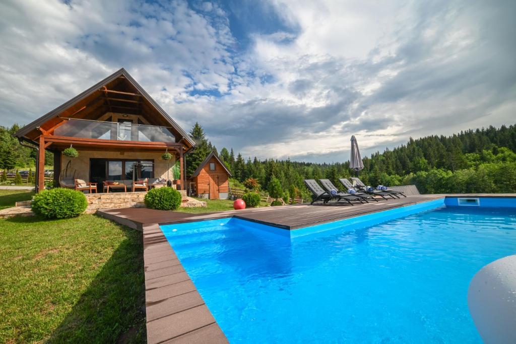 a log home with a pool and a house at Country Chic Villa with Pool in Mrginj
