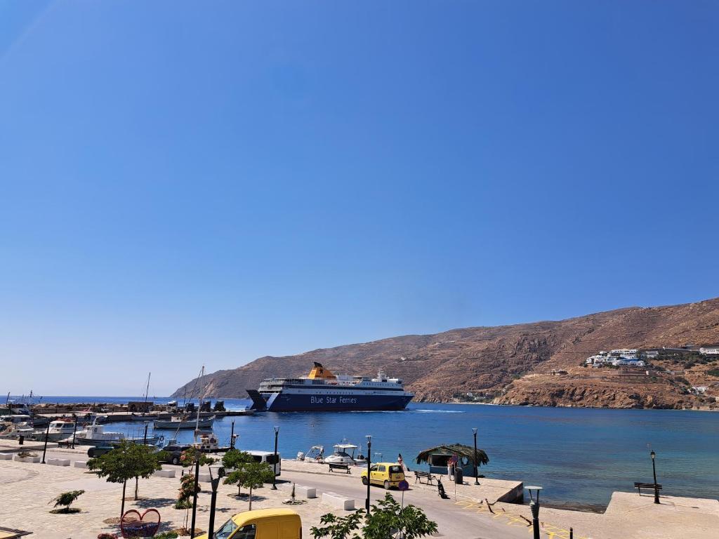 a large cruise ship docked in a harbor at ALSIDE Apartment in Aegiali