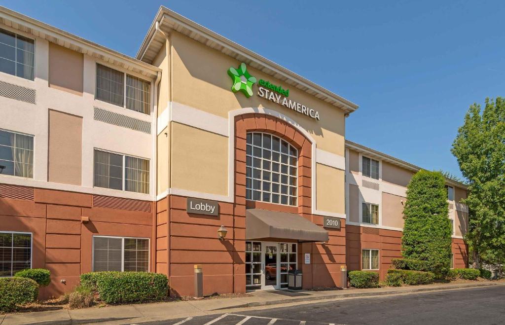 a building with a sign on the front of it at Extended Stay America Select Suites - Atlanta - Marietta - Wildwood in Atlanta