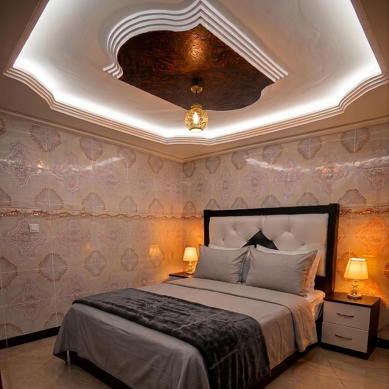 a bedroom with a large bed with a coffered ceiling at Aziz House 2 Tan Tan in Tan-Tan