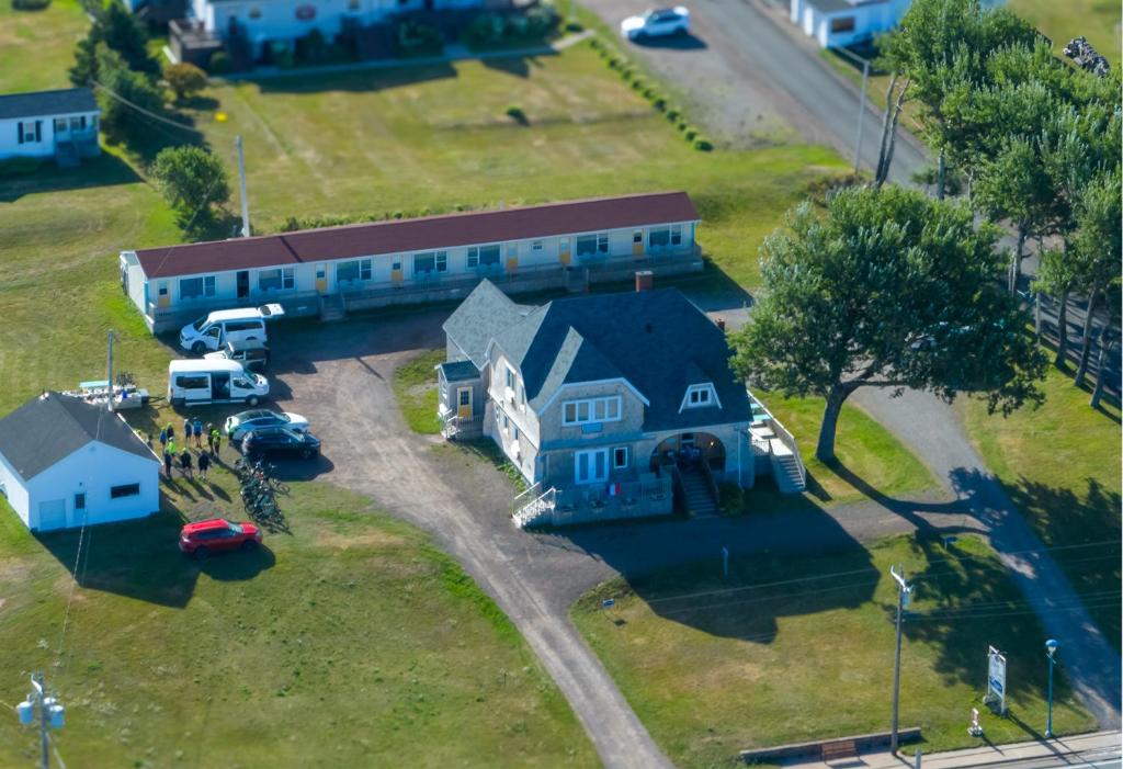 an aerial view of a house with a truck parked in front at Silver Lining Inn and Motel in Chéticamp
