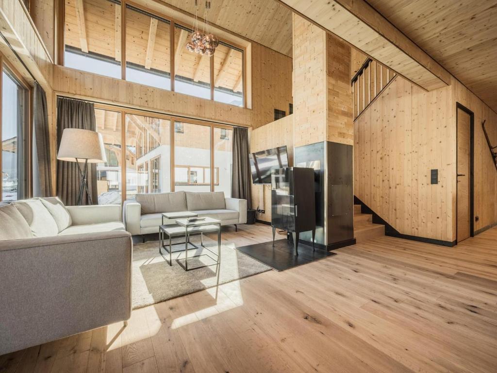 a living room with a couch and a table at Chalet with mountain views, Dein Bichlbach in Bichlbach