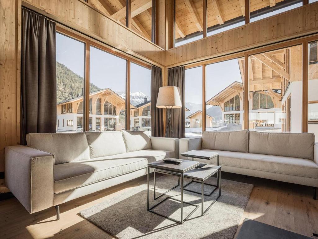 a living room with a couch and a table at Bichlbach Chalet with sauna in Bichlbach