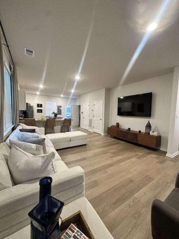 a living room with two couches and a flat screen tv at Milford House in Milford