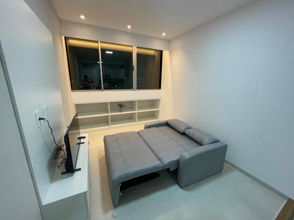 a small bed in a room with a window at White Life in Caruaru