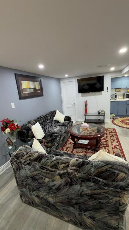 a living room with a couch and a table at Beautiful lake view Basment room in Brampton