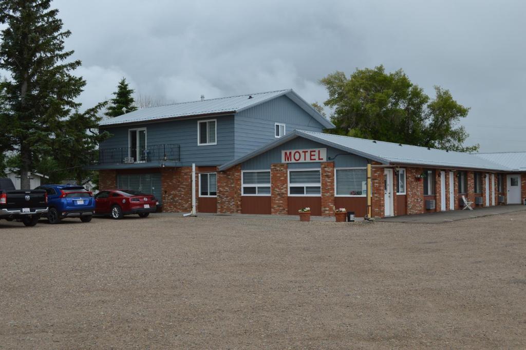 a motel with a car parked in front of it at A1 Motel And Campground in Bassano