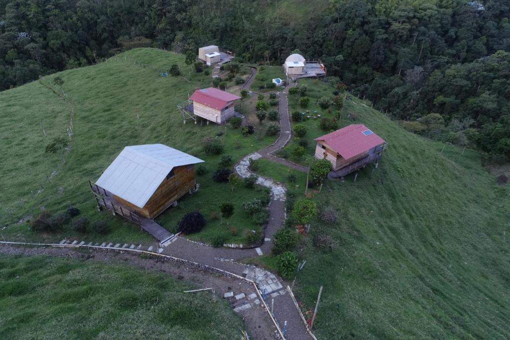 an aerial view of a farm with buildings on a hill at La Alborada Glamping in Filandia