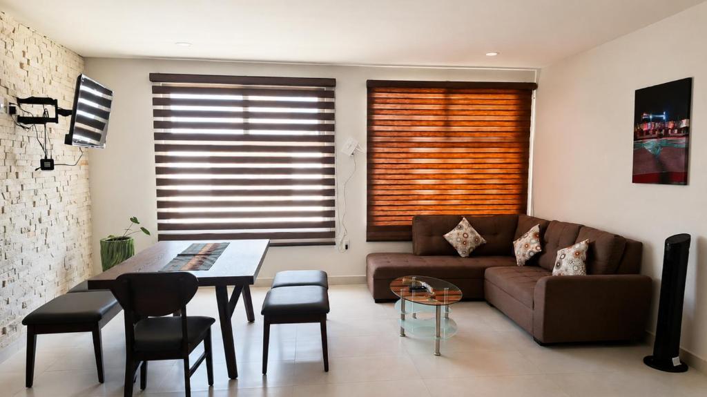 a living room with a couch and a table at Nuevos departamentos en Valle de Bravo in Valle de Bravo